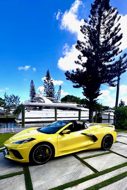 Corvette C8 rental with boat in background, Fort Myers Florida